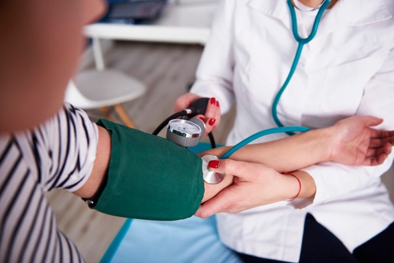 Woman getting her blood pressure checked by nurse