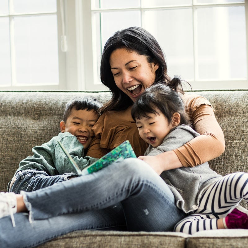 Mother reading with kids on the couch