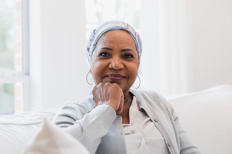 Serene female senior adult cancer patient smiles for camera